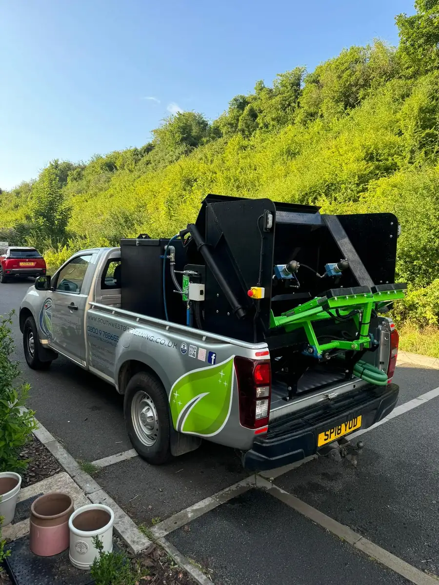 Bin wash rig with hydraulic lift on a South West Bin Cleaning Co pickup