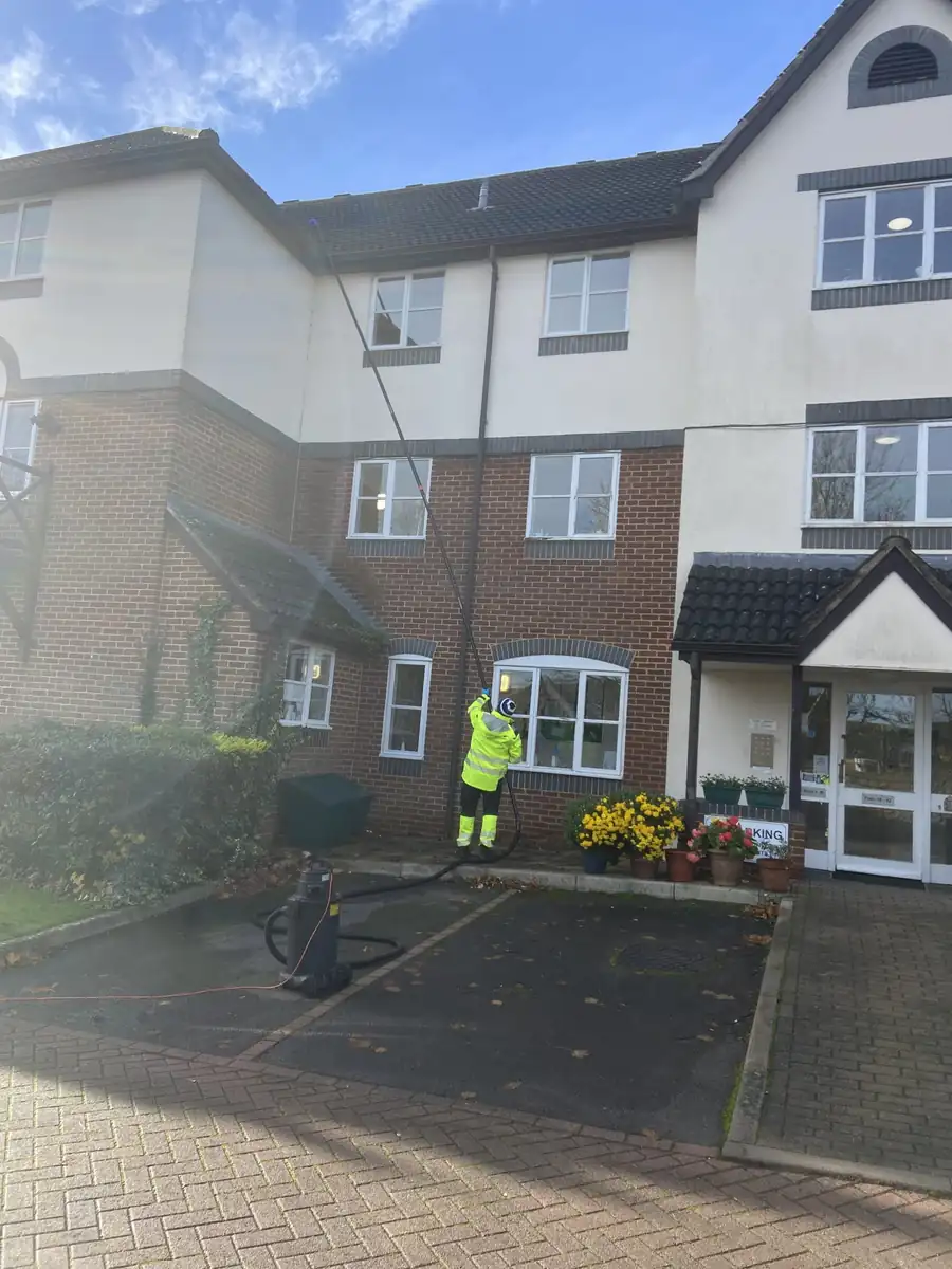 Gutter vacuum pole clearing gutters on a house South West Bin Cleaning Co