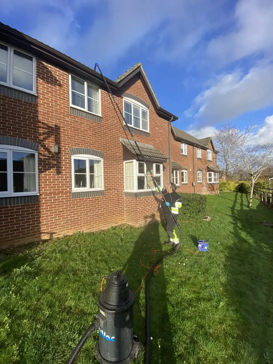 Gutter vacuum equipment in use at a block of flats South West