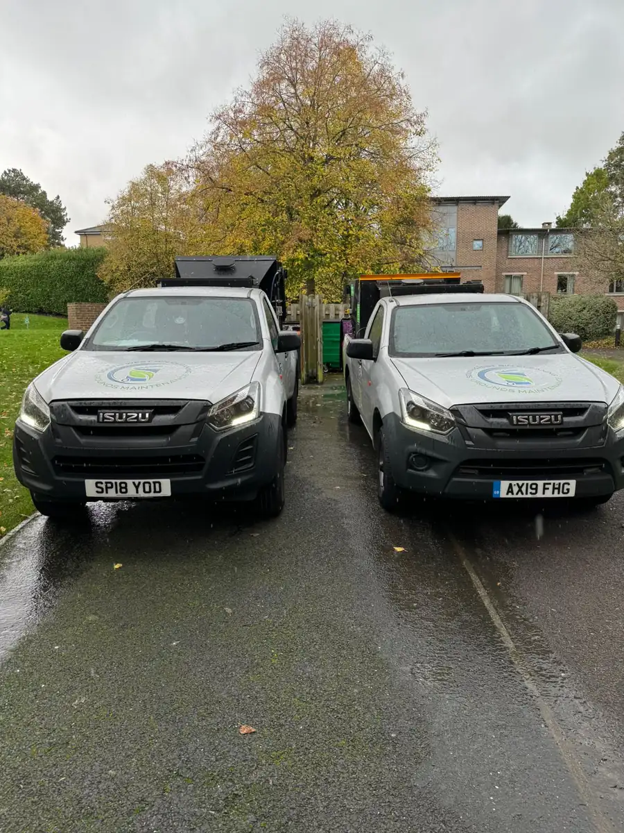Two South West Bin Cleaning Co pickups parked at a residential site